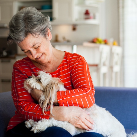 Resident relaxing at home with her dog